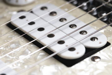 Close-up of electric guitar pickups with strings. Music background