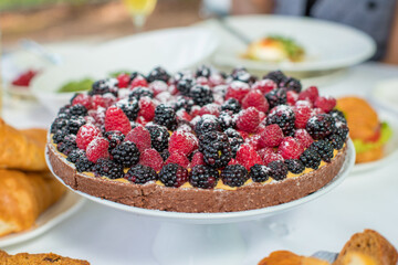 Delicious raspberry  tart (tartlet) with whipped cream. Breakfast Buffet Concept, Breakfast Time. Various brunch on the table