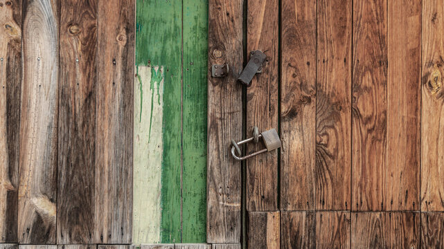Detail of the locks on an old wooden slat door
