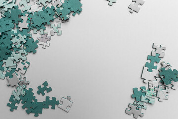 White and green puzzles lie around an empty white space