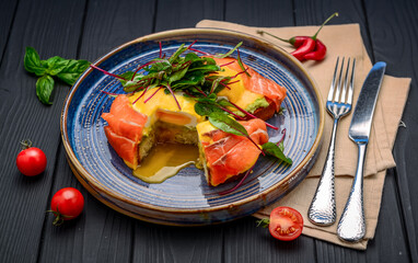 Toast with salmon, poached egg and avocado on a plate.
