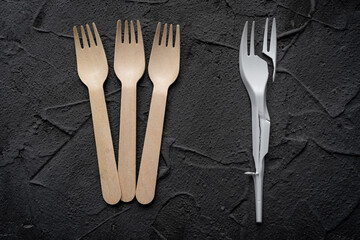 Zero waste concept poster. Reusable wooden cutlery vs plastic cutlery.  Eco friendly zero-waste concept. Top view with space for text. Copy space