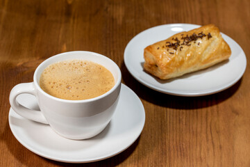 cup coffee and pain au chocolat