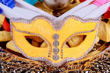 Jewish carnival Purim celebration on noisemaker and mask