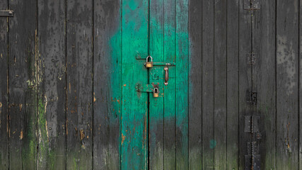 Detail of the locks on an old wooden slat door