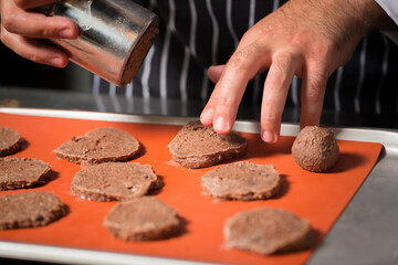 Chef preparing cookies in his kitchen.