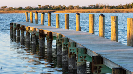 Wooden Pier leading out into an inlet.