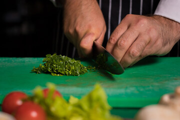 Chef cook preparing vegetables in his kitchen.