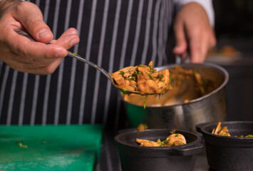 Chef cook preparing eggs  in his kitchen.Early meal with fried eggs served in pan. Breakfast Buffet Concept, Breakfast Timeю. Various brunch on the table
