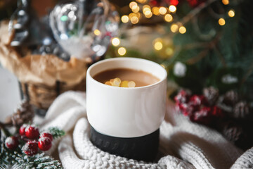 Hot chocolate in a beautiful cup on the Christmas table. Beautiful New Year's still life with a hot winter drink