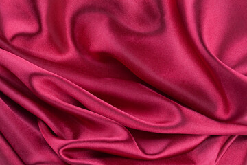red silk fabric with waves, elegant wallpaper design, abstract background