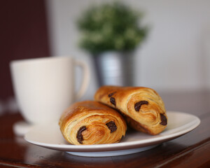 cup of coffee with croissant