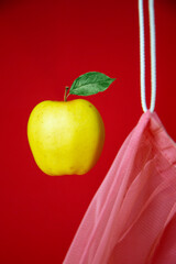 Yellow apple with eco-bag on the red  background.  The concept of healthy eating and healthy foods.