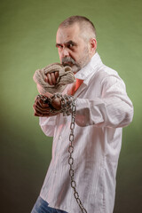 Aggressive elderly man with a chain in his hand