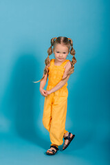 Happy little girl, studio shot. Children emotions, smiling blonde.
