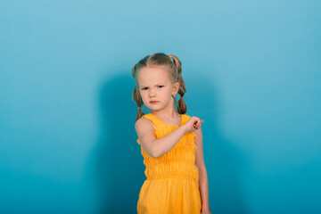Happy little girl, studio shot. Children emotions, smiling blonde.