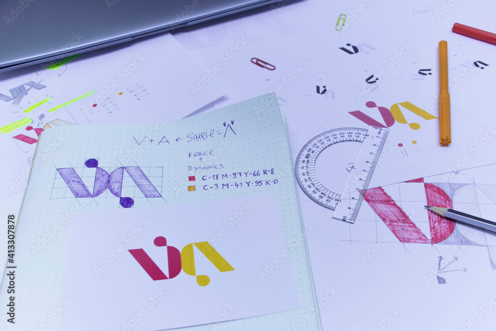 Poster sketches and drawings of the logo printed on paper. development of logo design in the studio on a ta