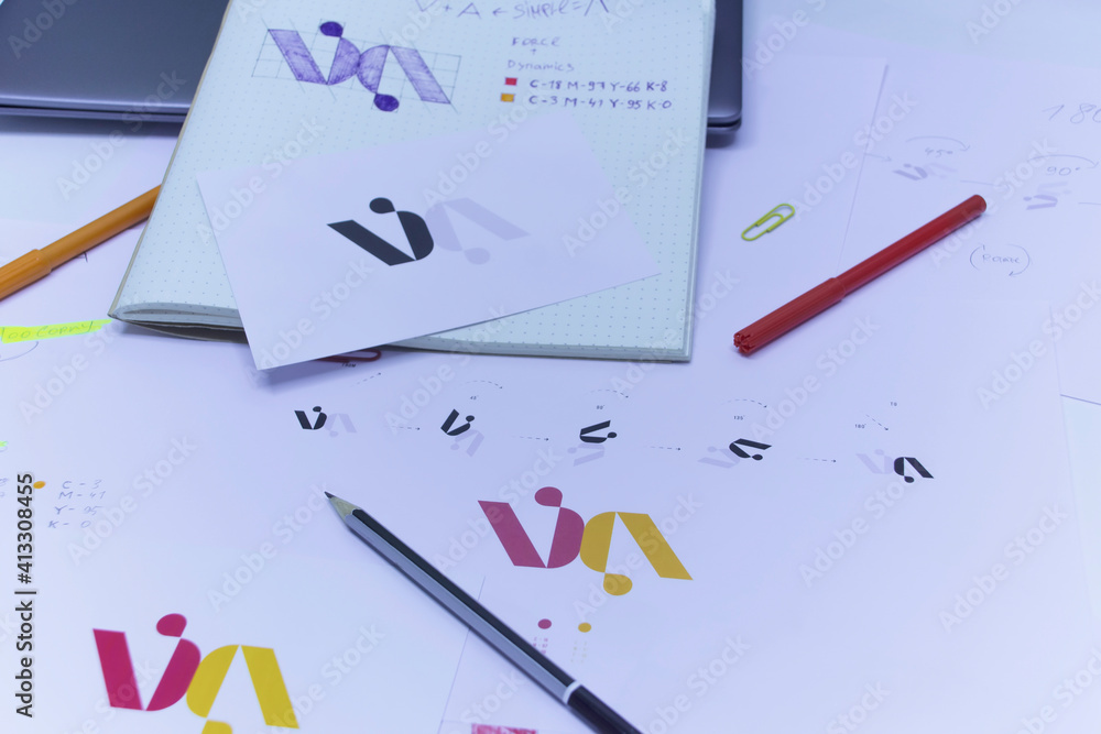 Poster sketches and drawings of the logo printed on paper. development of logo design in the studio on a ta