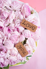 pink fresh roses  with love you written. romantic and wedding  concept background. close up. top view