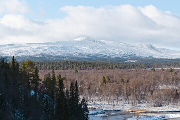 A winter view of the Vålån River and the hill in Vålådalen in northern Sweden