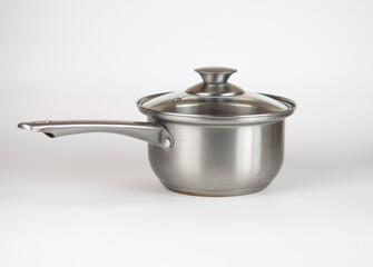 Stewing pan with glass lid on white background