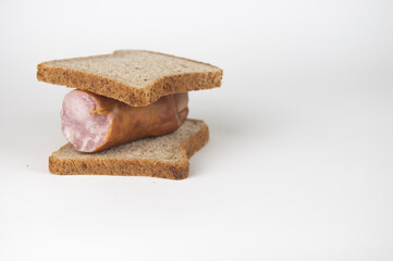 sandwich with sausage on white background. Breakfast, fast food