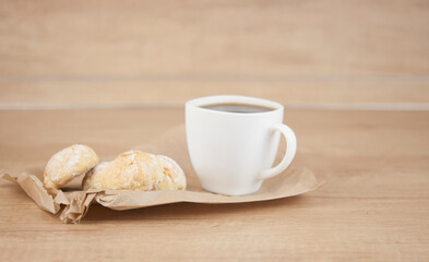orange snowball cookies with coffee cup on wood table