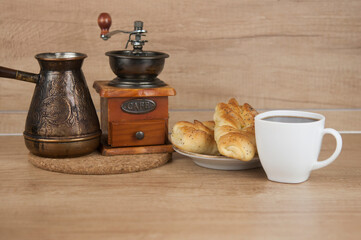 Two bun with poppy seeds with coffee cup on wood table. Breakfast. Good Morning
