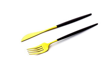 Golden fork and knife close-up on white background. Flatware for food. Kitchen utensils.