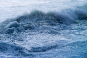 giant waves breaking on a stormy day in atlantic sea ocean
