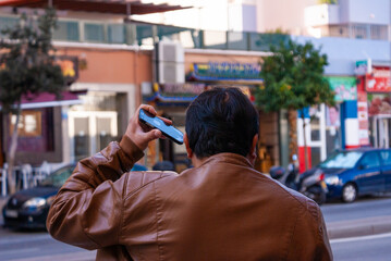 Man listening to an audio message puts the mobile phone near his ear