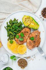 Avocado, chicken meat and string beans on a white background. Top view, vertical. The concept of healthy food.