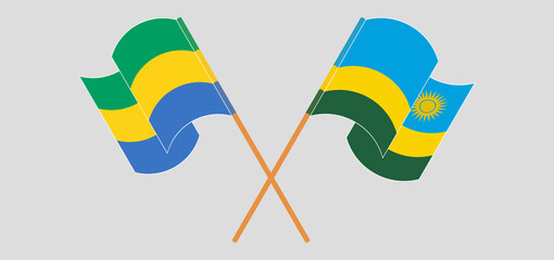 Crossed and waving flags of Gabon and Rwanda