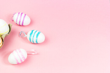 Colorful Easter eggs on a pink background. Copy space. Celebrating Easter