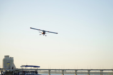 The plane is flying over the bridge. Air show in honor of the day of the city of Dnipro.