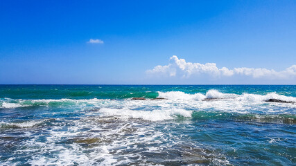 Turkey, one of the most beautiful sights and spectacular nature of antalya summer day sparkling blue sea sparkling waves and rocks.