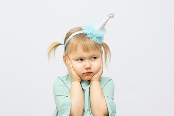 little sad girl in funny hat