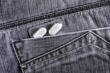 Pills in jeans pocket. Blister pack of white pills in back jeans pocket. Care health concept