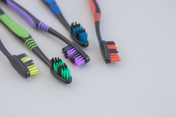Set of multicolored toothbrushes on gray background