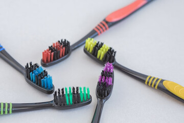 Set of multicolored toothbrushes on gray background