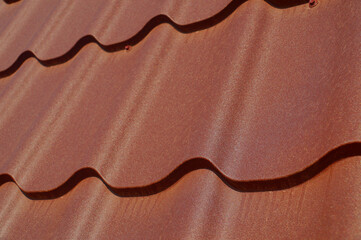 A fragment of a roof made of steel tiles. A frequently used method of covering the roof.