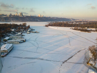 The frozen Dnieper river in Kiev. Aerial drone view. Winter sunny frosty morning.