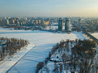 The frozen Dnieper river in Kiev. Aerial drone view. Winter sunny frosty morning.