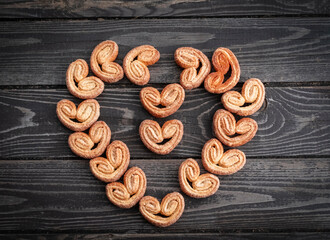 heart shaped cookies on a wooden dark background, flat lay