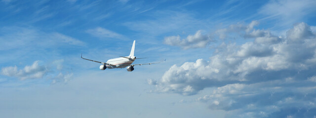 Zoom ultra wide photo of passenger airplane taking off in deep blue sky and beautiful clouds