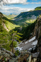 High mountains covered with dense forest, a lake in the distance. Montana, United States