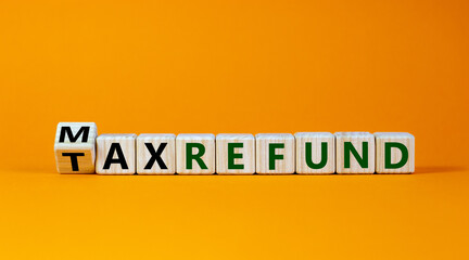 Max tax refund symbol. Turned wooden cubes with words 'max tax refund'. Beautiful orange background, copy space. Business and max tax refund concept.