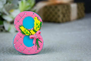 Brooch made of polymer clay in the shape of the number 8. Concept for seasonal holiday or girl birthday party