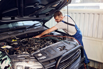  Mechanic connects air conditioning system on auto service