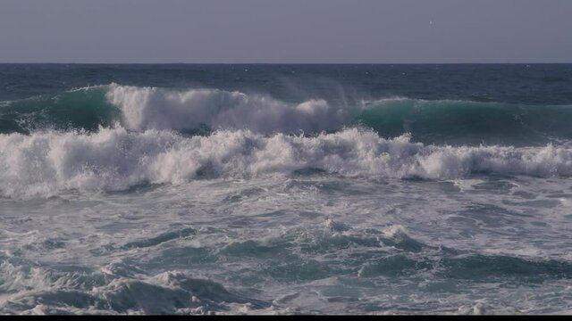 Big violent waves crash and create dangerous turbulent water and rip tides